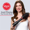 Woman holding a Revlon hairbrush with Allure Best of Beauty Award 2025 badge.