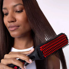 Woman using a black and red hairbrush on her long, straight hair