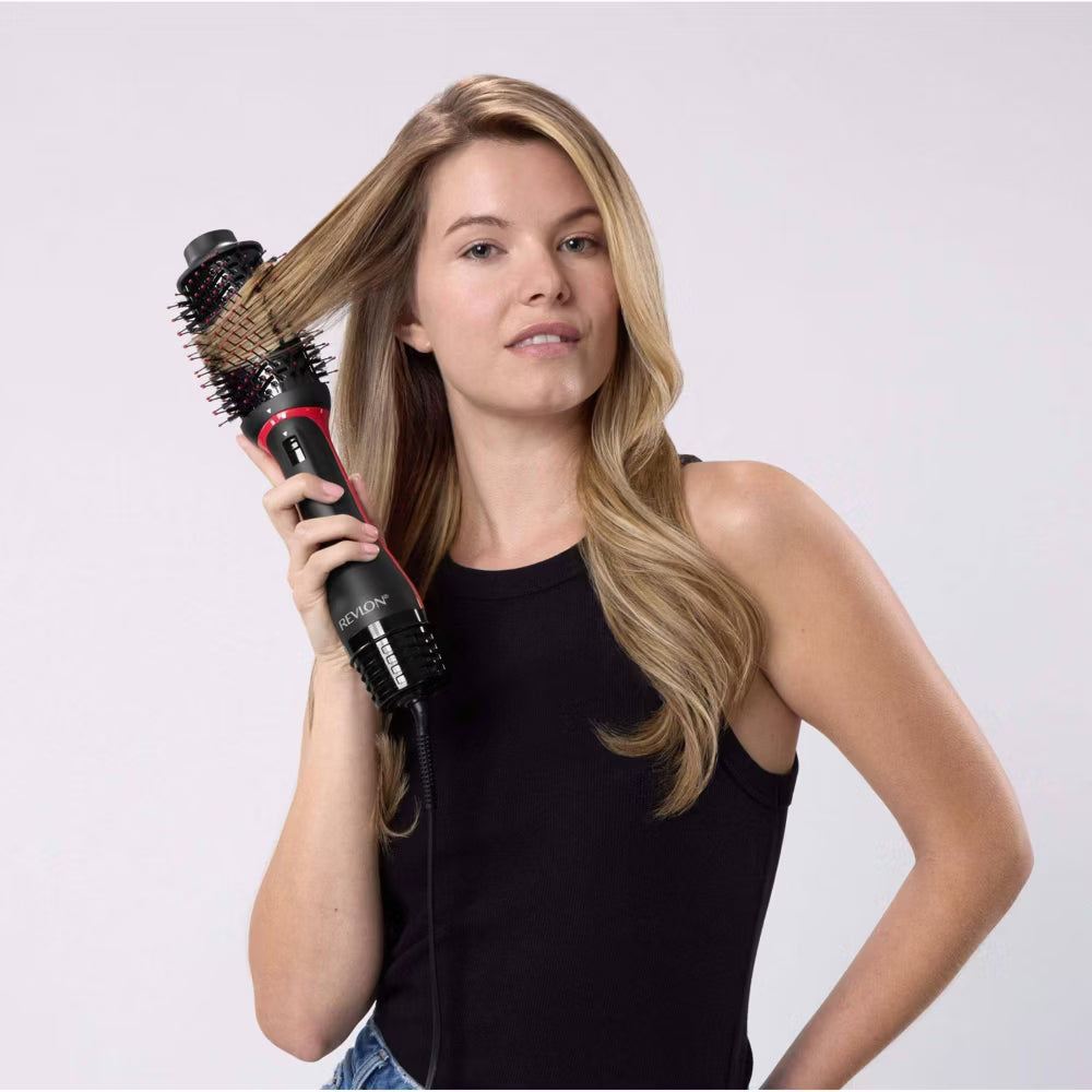 Woman holding a hair styling tool.